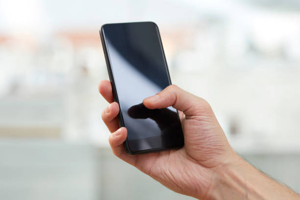 istock Male hand holding mobile phone 1020543546