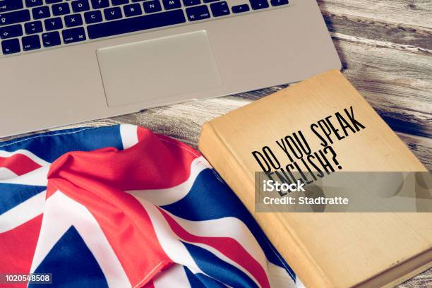 A Computer Flag Of Great Britain And Book Titled Speak English Stock Photo - Download Image Now