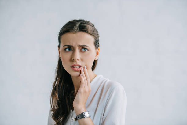 istock attractive young woman suffering from toothache and looking away 1020548644