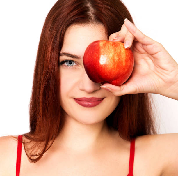 istock Young woman holding red apple 1020548674
