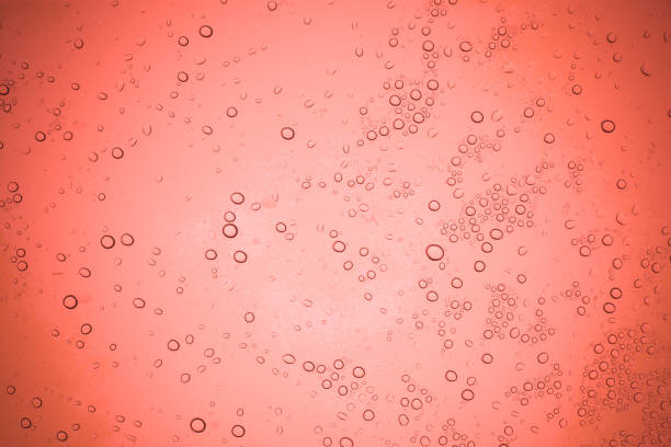 istock Rain droplets on red glass background, Water drops on glass. 1020553020
