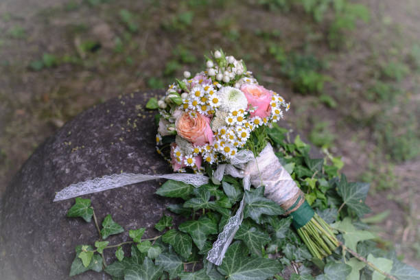 istock Bridal bouquet with rose, daisy, against forest background. 1020559046