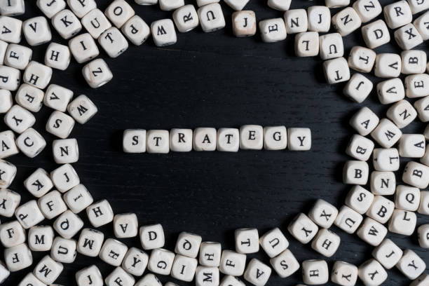 istock Word STRATEGY on wooden cubes on a black wooden table with copy space 1020563830