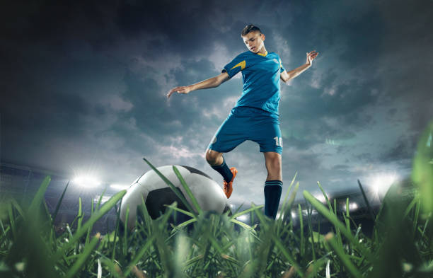 The soccer player kicking the ball at stadium The soccer player kicking the ball at stadium. 3D model of the stadium was created by me (the author) football boot stock pictures, royalty-free photos & images