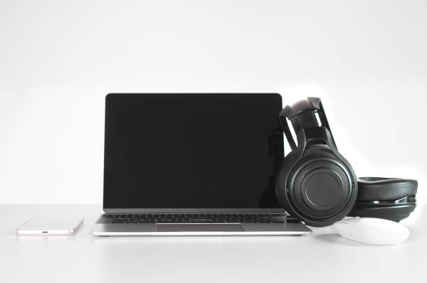 istock Headphones black, smartphone and laptop on Work Desk. 1020581290