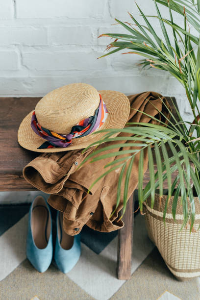 istock straw hat and jacket on wooden bench in corridor 1020585572