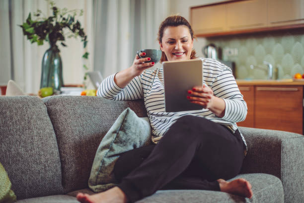 istock Woman is reading an ebook at home 1020586356