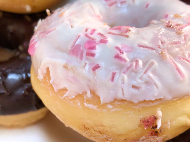 istock Fresh donuts with white frosting in plate 1020587076