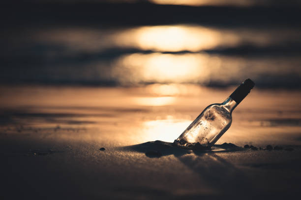 istock a message in the bottle found at the beach during sunset 1020587152