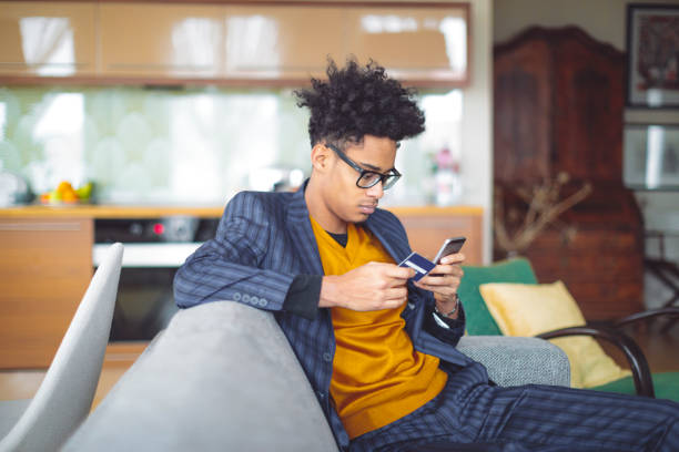 istock Young man shopping online at home 1020591568