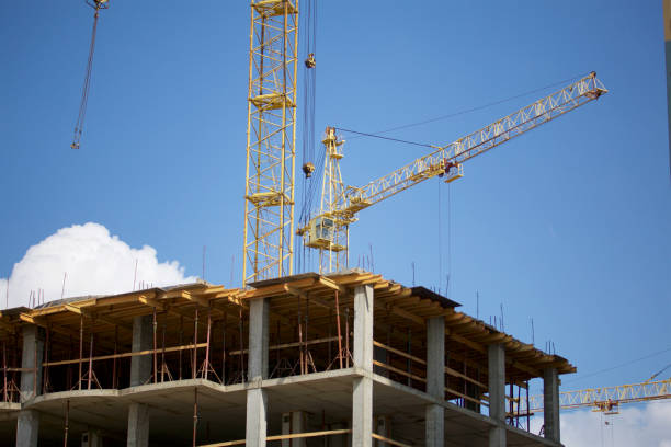 istock Tower building crane against the blue sky. The buildings under construction are visible. 1020593478