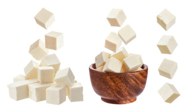 Feta isolated. Falling pieces of white cheese Greek feta cubes. Diced soft cheese isolated on white background with clipping path white cheese stock pictures, royalty-free photos & images