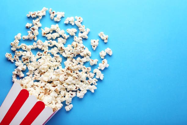 istock Popcorn in paper bag on blue background 1020600048