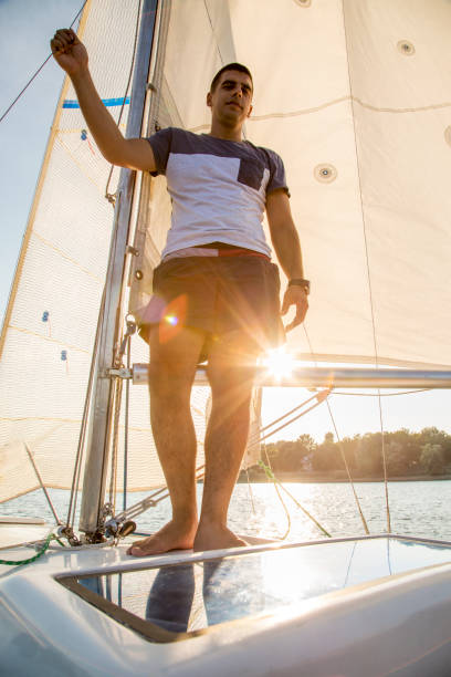 istock Young man on the sailboat. 1020608518