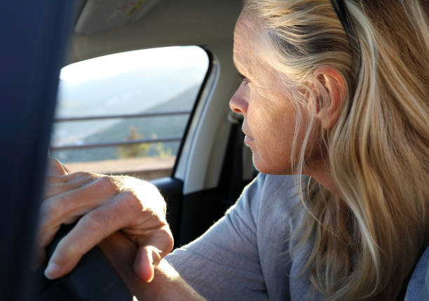 istock Woman looks out window while driving 1020608790