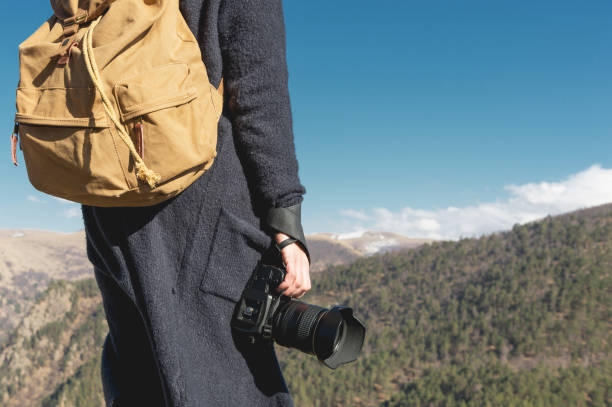 istock Photographer holding a camera outdoors. Girl on nature. Back view 1020608794