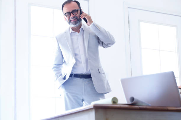 istock Latino Man Talking On Mobile Phone In His Office 1020614168