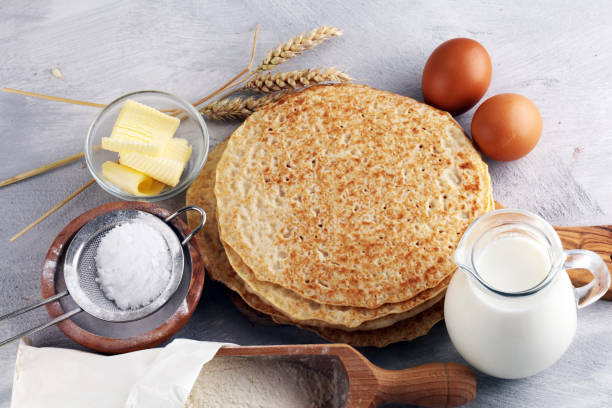 istock Homemade crepes served with fresh raspberrries and powdered sugar on rustic table. 1020638190