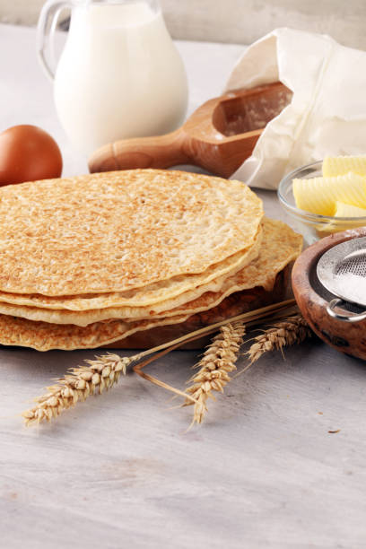 istock Homemade crepes served with fresh raspberrries and powdered sugar on rustic table. 1020638682