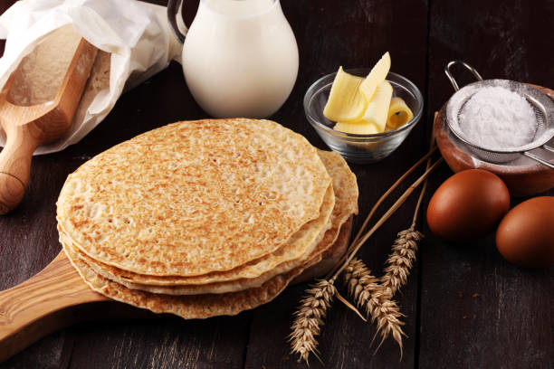 istock Homemade crepes served with fresh raspberrries and powdered sugar on rustic table. 1020639082