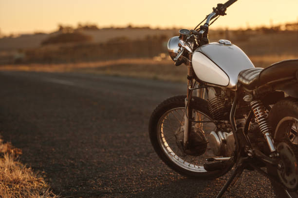 vintage motorcycle on country road - motocicleta imagens e fotografias de stock