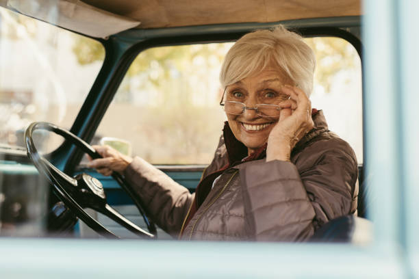 istock Elder woman driving a old car 1020639196