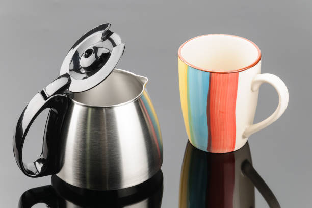 istock Coffee pot with coffee cup on the grey mirror background 1020643402
