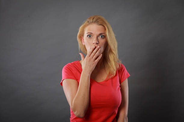 istock Shocked woman holding hand on lips 1020644432