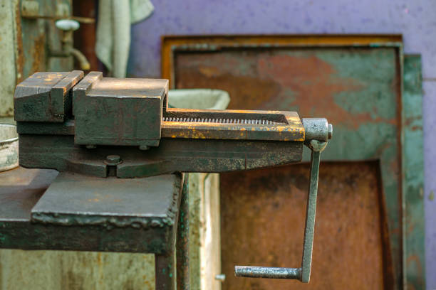 istock Old metal manual vise tool, in the home workshop on workbench. Vice is tool for industrial works. Selective focus. 1020657734