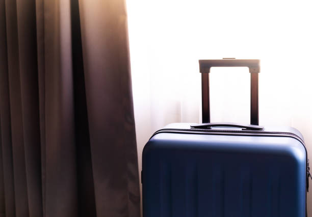 istock passenger luggage bag in bed room, ready for vacation 1020667570