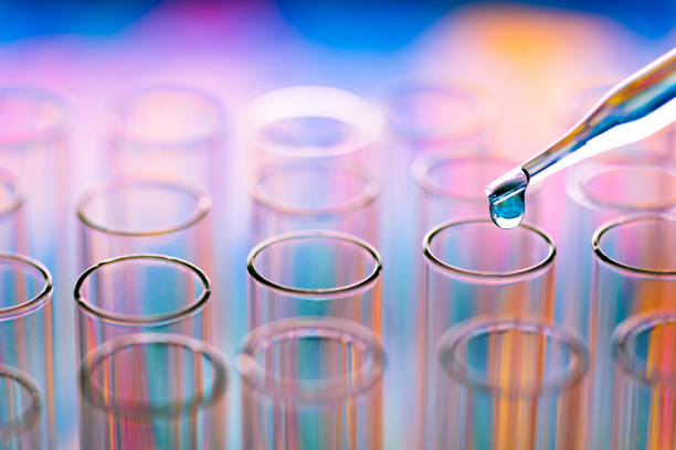 istock Close-Up Of Liquid Drop Falling From Pipette In Test Tube 1020686894