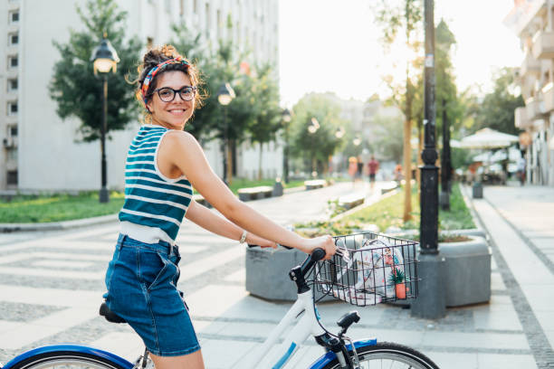 istock Joyful woman riding a bicycle 1020692830