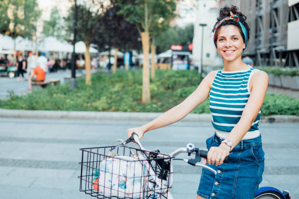 istock Joyful young woman on a bicycle 1020692892