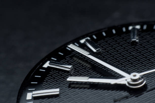 istock Close up clockwise on black clock face background. Wristwatch in retro style 1020703738