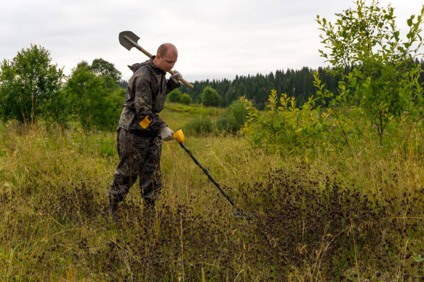 istock treasure hunter with shovel and metal detector 1020703764