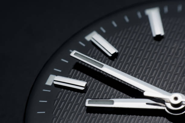 istock Close up clockwise on black clock face background. Wristwatch in retro style 1020703772
