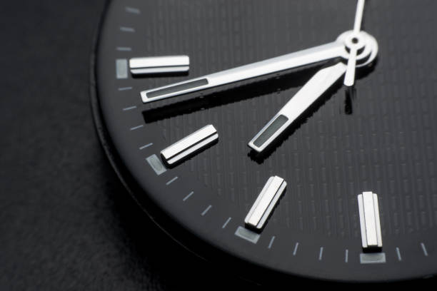 istock Close up clockwise on black clock face background. Wristwatch in retro style 1020703838