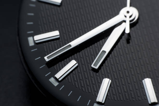 istock Close up clockwise on black clock face background. Wristwatch in retro style 1020703892