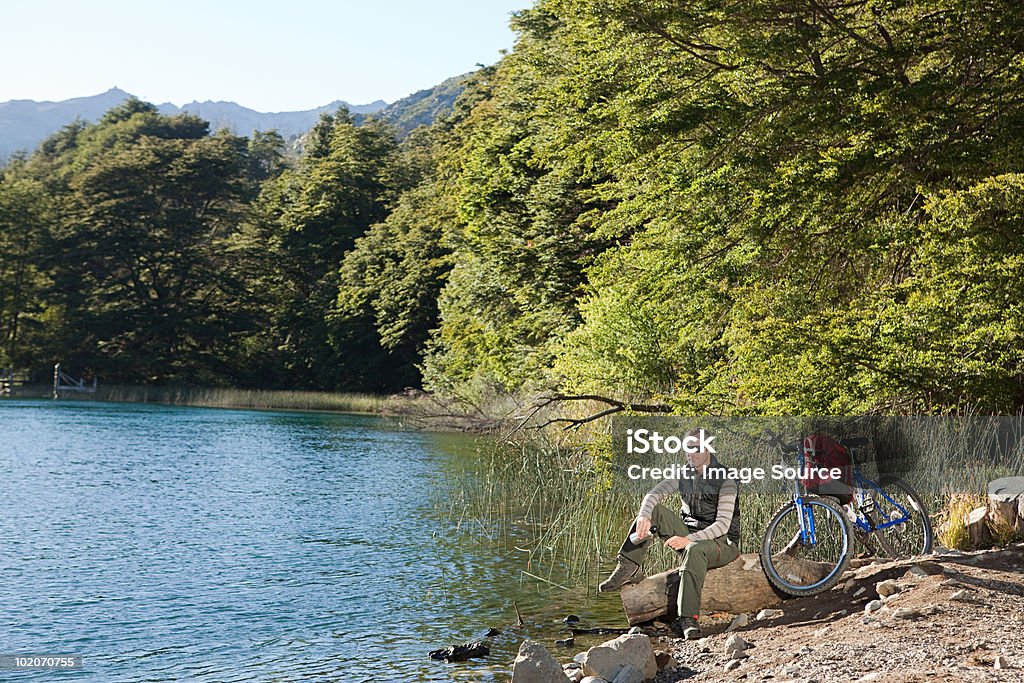 Man with mountain bike by lake  35-39 Years Stock Photo