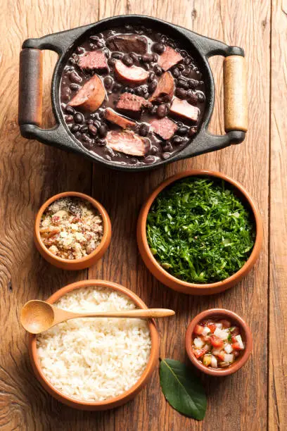 Feijoada is is a stew of beans with beef and pork of Portuguese origin, very popular in Brazil, and it is considered a national  dish, and accompanying dishes are: rice, farofa, and kale.