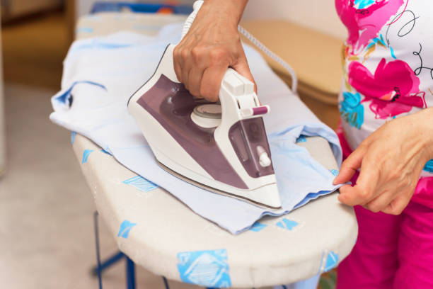 istock Senior woman close up ironing clothes 1020715406