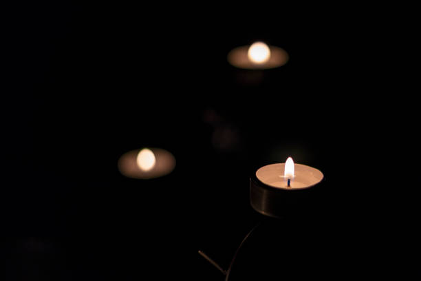 The candle burns in the dark