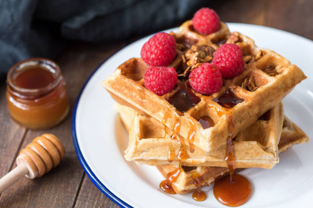 istock Belgian waffles with honey and berries on white plate 1020721014