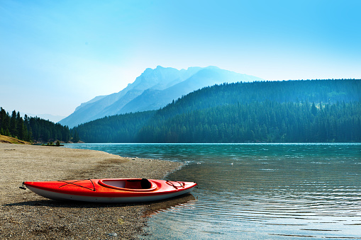 A red Kayak in the lakes in Banff National Park of Canada