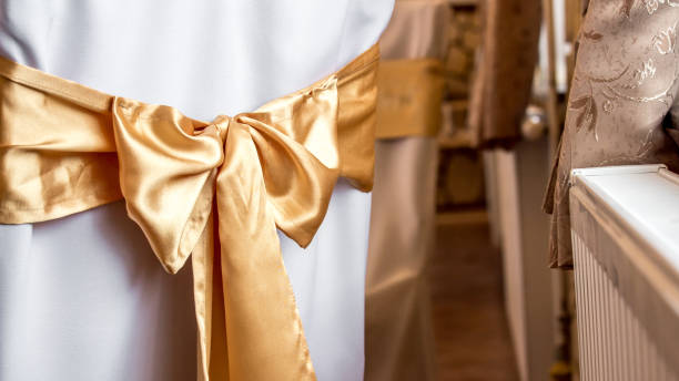 istock Golden Bow on a White Chair Cover 1020739140