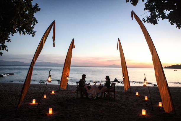 istock Couple dining on beach at sunset 1020739546