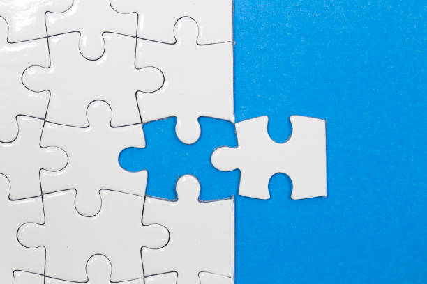 istock Blue background made from white puzzle pieces and place for your content 1020739764