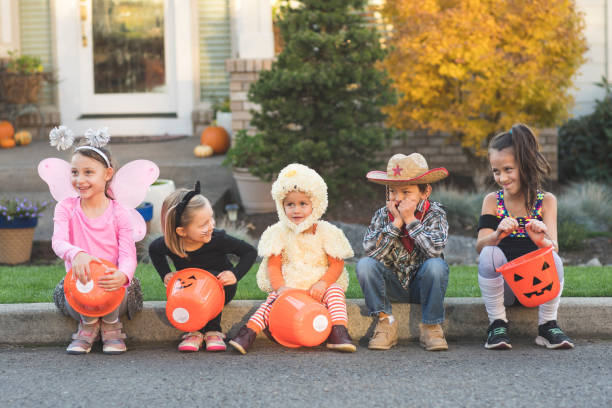 istock Trick or treaters sitting on a curb 1020755340