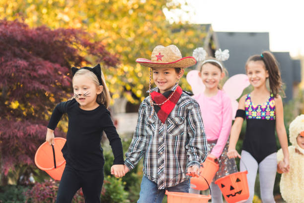 istock Multiethnic group of kids trick or treating 1020755356