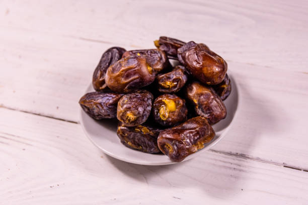 istock Date fruits on the white wooden table 1020763820
